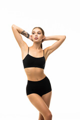 Fototapeta na wymiar Laughing sporty woman in black bikini posing on grey background. Photo of attractive girl with slim toned body.