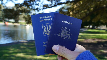 Two passports in hands. Two passports  Ukrainian and Australian
