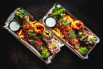 Grilled smoked pork ribs with french fries, onion rings, vegetables and sauce