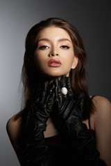 Fashion Woman in black gloves, portrait. Long hair, beauty beautiful eyes