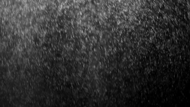 small drops of rain, snow on a black background. wind. Natural background. slow motion