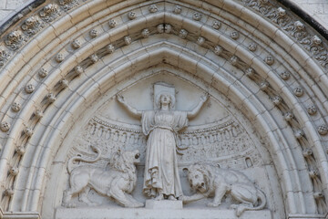 Fototapeta premium St. Blandine, patron saint of Lyon, depicted on the tympanum of a catholic church. Lyon, France.