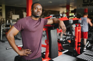 Handsome young African American man working out at the gym