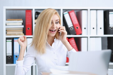 Beautiful blonde smiling businesswoman talk cellphone in office portrait. Stay in touch best cellular price A woman is informed that she won a prize in the lottery by phone