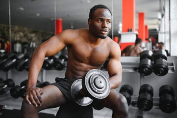 Fototapeta na wymiar African American young man doing workout at the gym