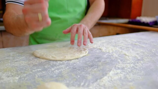 the chef is preparing pita dough