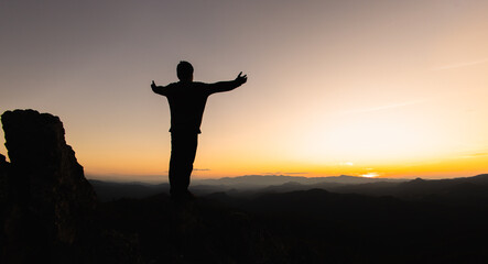 Human hands open palm up worship, Praying hands, Copy space of man rise hand up on top of mountain and sunset sky abstract background. Freedom and travel adventure concept.