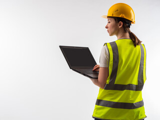 Woman industrial engineer. Factory manager with laptop. Girl engineer with back to camera. Woman...