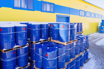 Blue barrels on pallets. Place to store fuel. Metal barrels with gasoline. Storage area near...