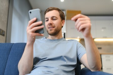 Online payment,Man holding a credit card and using smart phone for online shopping