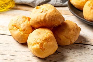 brazilian cheese breads (pão de queijo) in a wooden table. also known as cheese buns