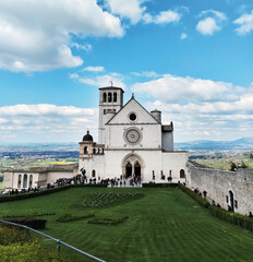 A captivating frontal view of the stunning Basilica of San Francesco in Assisi, Italy. The imposing...