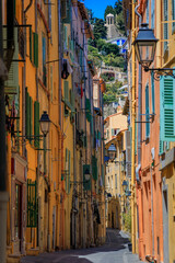 Fototapeta na wymiar Picturesque narrow streets with colorful traditional houses in the old town of Menton, French Riviera, South of France