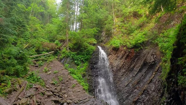 Stunning summer view from the deep canyon of Zhenetsʹkyy Huk waterfall. Beautiful morning scene of Carpathian mountains, Ukraine, Europe. 4K video (Ultra High Definition).