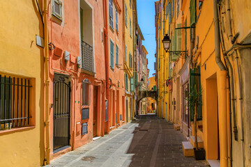 Fototapeta na wymiar Picturesque narrow streets with colorful traditional houses in the old town of Menton, French Riviera, South of France