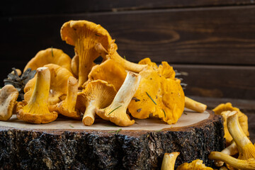 Chanterelle mushrooms on a wooden background with free space.
