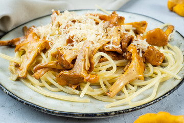 Delicious noodles, spaghetti with wild mushrooms and cheese, close-up.