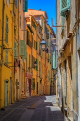 Fototapeta na wymiar Picturesque colorful traditional houses near the local farmers market in the Old Town, Vieille Ville in Menton, French Riviera, South of France