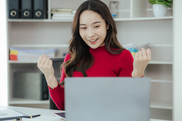 Fototapeta na wymiar Beautiful Asian woman working on laptop in home office