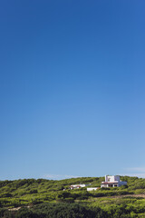 Fototapeta na wymiar Green overgrown hills and blue sky. Formentera