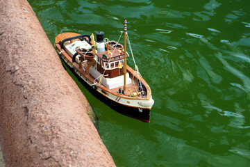 Fototapeta na wymiar A Radio Controlled Model of a Fishing Schooner Ship on the Water