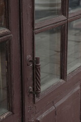 Metal handle on an old wooden door to the Gostiny Dvor building in the city of Ryazan
