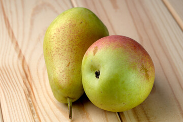 Sweet ripe pears on a wooden light table close-up, fruit composition