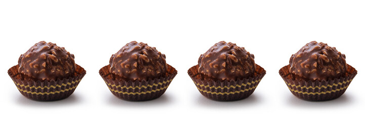 Chocolate and hazelnut pralines in a row. isolated white background
