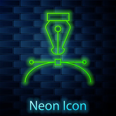 Glowing neon line Fountain pen nib icon isolated on brick wall background. Pen tool sign. Vector