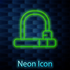 Glowing neon line Bicycle lock U shaped industrial icon isolated on brick wall background. Vector