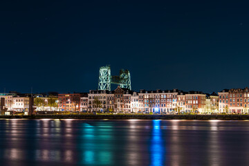 Immersed in the Timeless Beauty of Rotterdam's Nightfall, Where Skyscrapers Sparkle Amidst Reflections on the Water