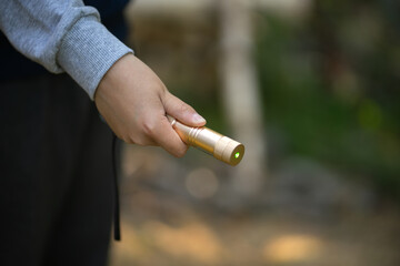 The child holds a laser pointer in his hand. The danger of the laser in children's games. Blinding with a laser toy.