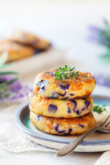 Vegetable fritters with sweet potatoes and red cabbage garnished with sour cream and thyme