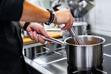 Obraz na płótnie Canvas Chef cook hand cooking food at the restaurant kitchen