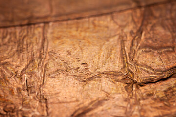 Extreme closeup of crumpled brass foil texture
