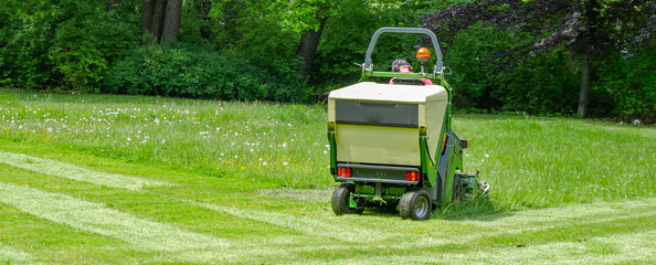 lawn mower on a field in the park