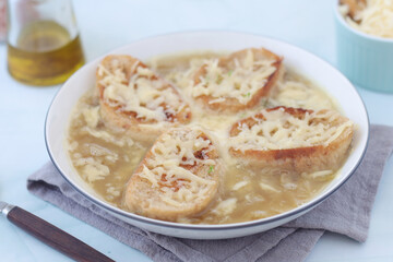A ceramic bowl with French onion soup