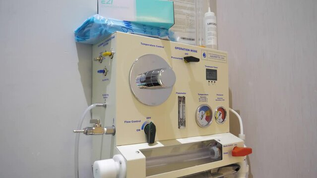 Slow motion tilting shot of a colon hydrotherapy machine in a clinic room