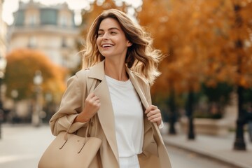Fototapeta premium Beautiful model woman walking with shopping bags, buying clothes in stores on a Paris street in France. Fashionable lady with high heels. from behind. Perfect for a advertisement.