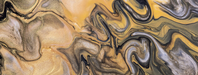 Abstract fluid art background black and golden colors. Liquid acrylic painting on canvas with...