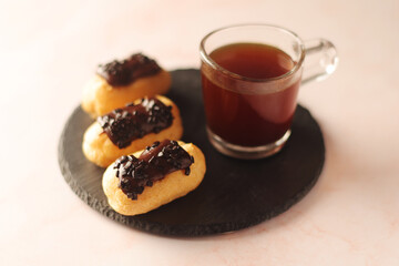 Traditional French dessert - eclairs with a cup of coffee