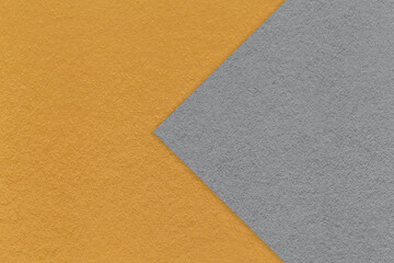 Texture of dark orange paper background, half two colors with gray arrow, macro. Craft ocher cardboard.
