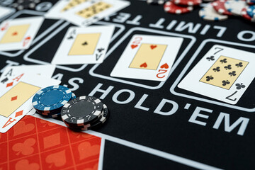 Perfect combination playing cards for win at poker with stack of chips on casino club table