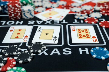 win poker combination cards and stack of chips on black casino table