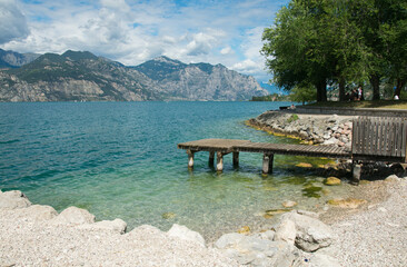 Wooden pier on Lake Garda (Lago di Garda) from the small town of Malcesine, Verona, Veneto Italy