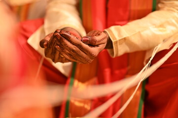 White thread around the bride and groom. Hands of the groom. Indian Marriage. Kanyadaan ceremony. Marathi Wedding Rituals and Ceremony. Maharashtra culture. 