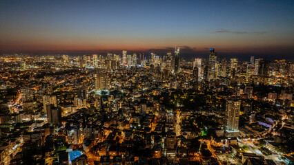 Night aerial view of Tel Aviv Yafo skyscrapers and Mediterranean sea