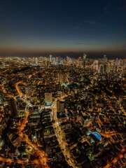 Night aerial view of Tel Aviv Yafo skyscrapers and Mediterranean sea