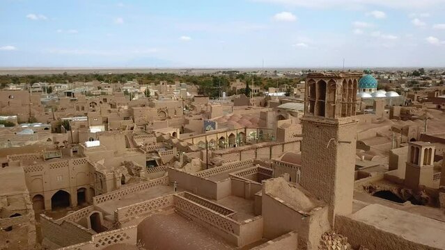 Blue sky white clouds and historical desert house in a village with adobe mud brick pattern windcatcher yards and traditional architect design ideas from birjand to Yazd to morocco Egypt middle east