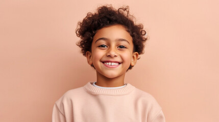 A happy, smiling boy in neutral clothing poses in front of a beige studio background. Generative AI